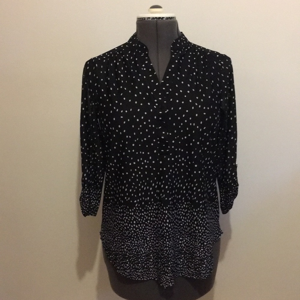 Black and white Polk a dot shirt.